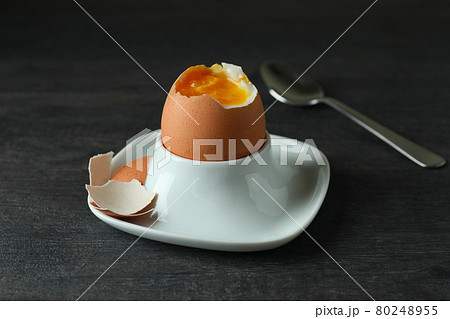 Concept of tasty breakfast with boiled egg on dark wooden table 80248955