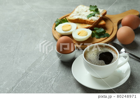 Concept of tasty breakfast with boiled eggs on gray textured table Concept of tasty breakfast with boiled eggs on gray textured table 80248971