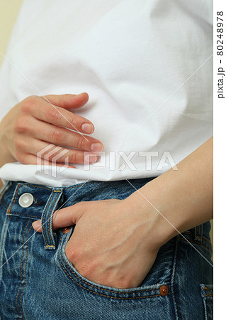 Young woman in white t-shirt and jeans, close up Young woman in white t-shirt and jeans, close up 80248978