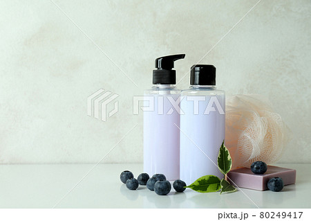 Natural bath cosmetics and blueberry against white textured background Natural bath cosmetics and blueberry against white textured background 80249417