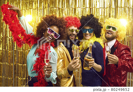 Group of four friends laughing sharing good and positive mood drinking champagne 80249652