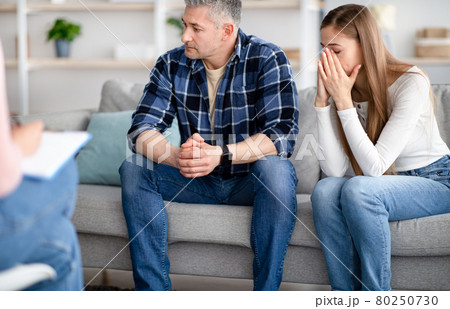 Mature couple seeking professional help, having consultation with psychologist at office 80250730