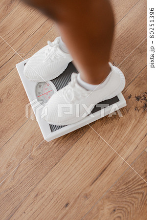 Slimming Concept. Closeup of Black Woman Standing On Scales 80251396