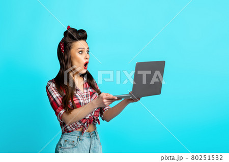 Online win, great offer, huge sale. Shocked pinup lady holding laptop, shouting OMG, happy about discount or victory Online win, great offer, huge sale. Shocked pinup lady holding laptop, shouting OMG, happy about discount or victory 80251532