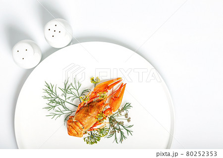 Boiled orange crayfish with dill on a white plate on a white background. Delicious crayfish with aromatic dill and spices. Blank for the menu. Organic wild food. Copy space. Top view Boiled orange crayfish with dill on a white plate on a white background. Delicious crayfish with aromatic dill and spices. Blank for the menu. Organic wild food. Copy space. Top view 80252353