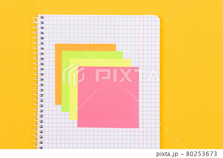 A Notepad with Sticky Notes on Yellow Table A Notepad with Sticky Notes on Yellow Table 80253673