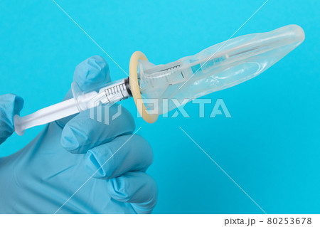 Anti Vaccination Concept - Syringe in a Condom Anti Vaccination Concept - Syringe in a Condom 80253678