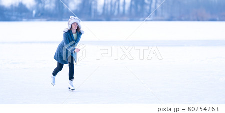 ice skating on a frozen pond in winter. banner 80254263