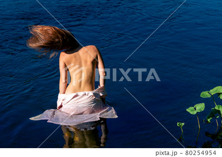 young woman swimming in the river without a swimsuit young woman swimming in the river without a swimsuit 80254954
