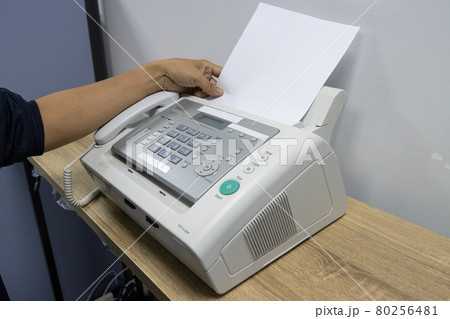 hand man are using a fax machine in the office, equipment for data transmission. 80256481