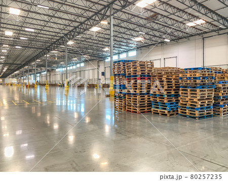 Massive Empty Industrial Warehouse Interior With Stacked Pallets Massive Empty Industrial Warehouse Interior With Stacked Pallets 80257235