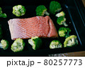 Fresh organic atlantic salmon fillet on baking tray with green broccoli florets as healthy food nutrition and keto diet 80257773