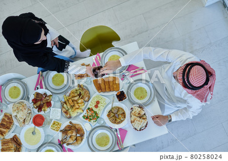 Muslim couple sharing dates for starting iftar top view 80258024