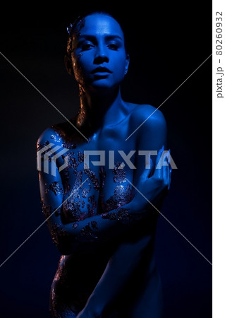 Nude woman with body art under neon illumination 80260932