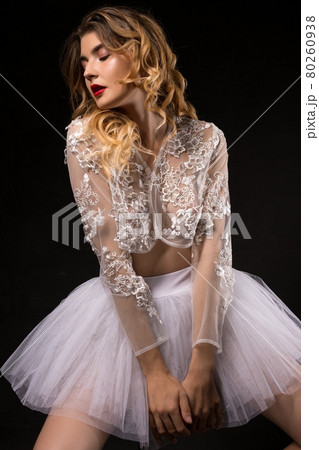 Seductive ballerina in white lacy clothes Seductive ballerina in white lacy clothes 80260938