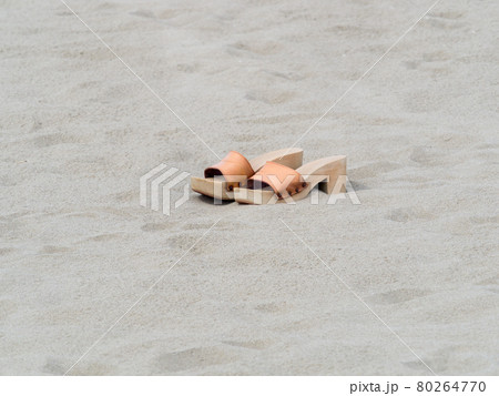 classic female handmade clogs on the beach in summer day 80264770