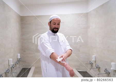 a portrait of a man in abdesthana using a towel a portrait of a man in abdesthana using a towel 80266563