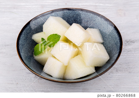 slices of fresh juicy melon, served with mint 80266868