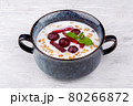 rice porridge with berries, served with mint 80266872