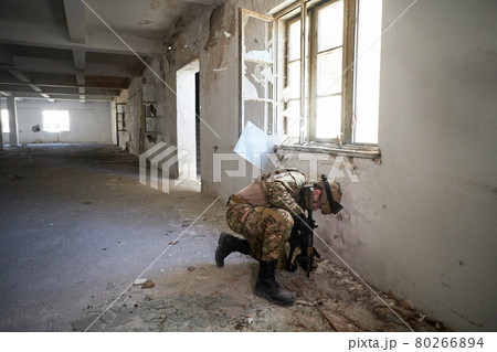 soldier in action near window changing magazine and take cover soldier in action near window changing magazine and take cover 80266894