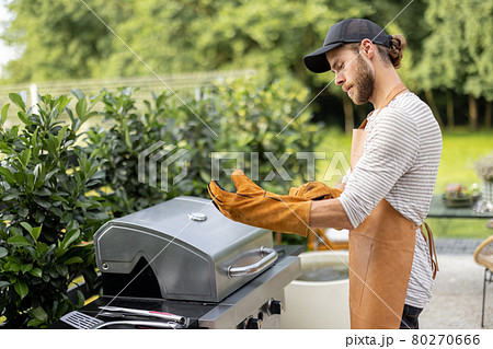 Handsome man preparing for cooking on grill 80270666