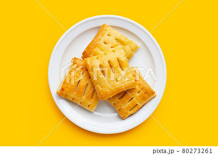 Pineapple pie in white plate on yellow background. Pineapple pie in white plate on yellow background. 80273261