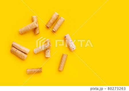 Thai crispy coconut rolls on yellow background. 80273263