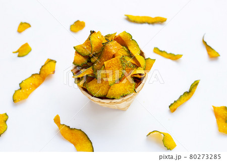 Green pumpkin slice chips on white background. Green pumpkin slice chips on white background. 80273285