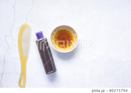 hair oil, comb and container on table , top view , 80273704