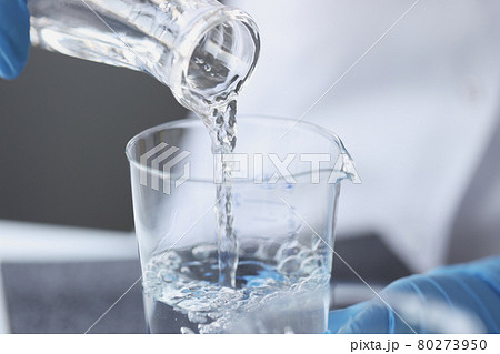 Scientist examines drinking water in laboratory closeup Scientist examines drinking water in laboratory closeup 80273950
