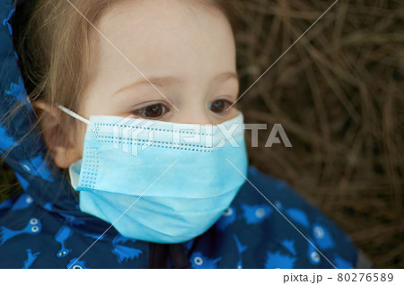 Close up of Little girl with protective mask looking up Close up of Little girl with protective mask looking up 80276589