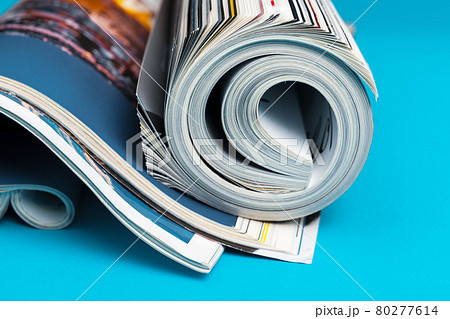 Glossy magazine with pages rolled Glossy magazine with pages rolled 80277614