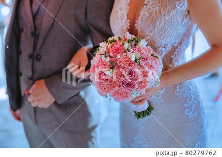 wedding couple holding a bouquet for the wedding wedding couple holding a bouquet for the wedding 80279762
