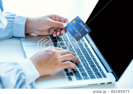 Consumer woman hand holding a mock up credit card, Ready to spending pay online finance shopping according to discount products via laptop from home office 80280975