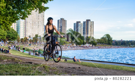 Adventurous White Caucasian Adult Woman riding a road bicycle in Stanley Park 80282221
