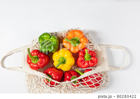 Zero waste concept. Vegetables in eco friendly string bag on white background. 80283422