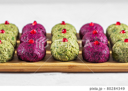 Pkhali with beets and beans on a cutting board on a white background. Traditional Georgian dish of vegetables, walnuts and spices 80284349