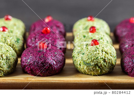 Pkhali with beets and beans on a chopping board closeup. Traditional Georgian dish of vegetables, walnuts and spices 80284412