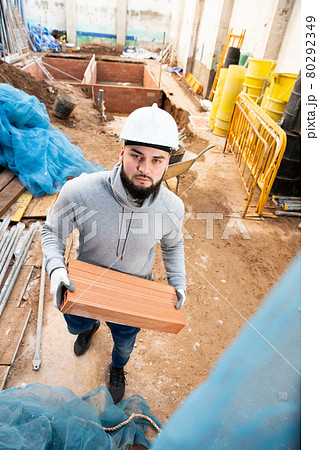 Builder working with red brick Builder working with red brick 80292349