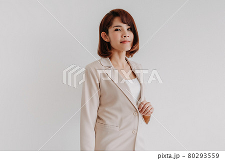Confident Asian working woman in beige blazer isolated on white. 80293559