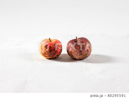 Trendy ugly food concept. Two rotten apples on a white background. The problem of food waste. 80295591
