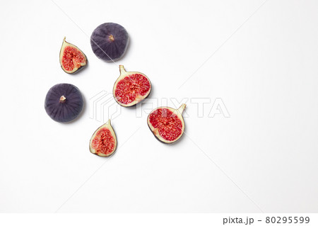 Fresh figs isolated on white background with space for text. Food Photo. Copy space. Purple figs with red seeds. Flat lay, top view Fresh figs isolated on white background with space for text. Food Photo. Copy space. Purple figs with red seeds. Flat lay, top view 80295599