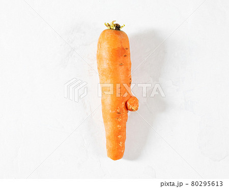 Trendy ugly food concept. Funny carrot on a white background. Vegetable with a strange shape. The problem of food waste. 80295613