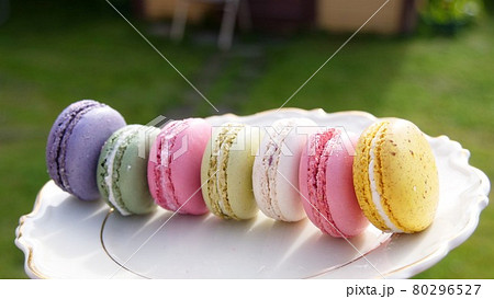 Cake macaron or macaroon on green background colorful almond cookies, pastel colors, Cake macaron or macaroon on green background colorful almond cookies, pastel colors, 80296527