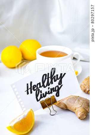 HEALTHY LIVING - written on piece of paper among the products for the treatment of common cold - lemon, ginger, chamomile tea. Vitamin natural drink HEALTHY LIVING - written on piece of paper among the products for the treatment of common cold - lemon, ginger, chamomile tea. Vitamin natural drink 80297157