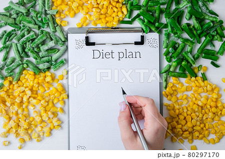 DIET plan. Frozen vegetables food of yellow corn, green beans. Harvest Food preservation for winter. Veganism, vegetarian healthy eating DIET plan. Frozen vegetables food of yellow corn, green beans. Harvest Food preservation for winter. Veganism, vegetarian healthy eating 80297170