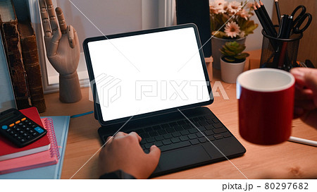 Close up view female drinking coffee and using computer tablet. 80297682