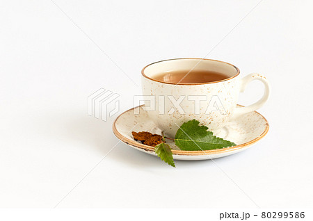 Cup of chaga tea isolated on a white background. Healthy beverage with birch mushroom. Cup of chaga tea isolated on a white background. Healthy beverage with birch mushroom. 80299586