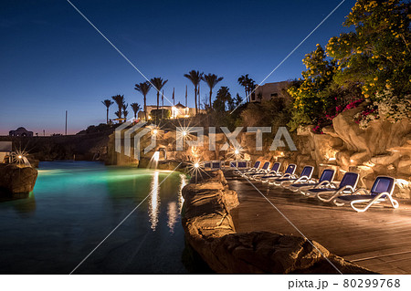 Long exposure shot of swimming pool at luxury night illumination Long exposure shot of swimming pool at luxury night illumination 80299768
