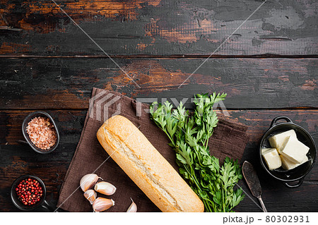 Homemade tasty bread with garlic, and herbs ingredients, on old dark wooden table background, top view flat lay, with copy space for text 80302931